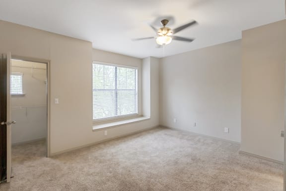 This is a picture of the primary bedroom of the 1320 square foot 2 bedroom, 2 and 1/2 bath floor plan at The Brownstones Townhome Apartments in Dallas, TX..