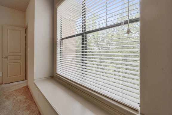 This is a picture of the recessed window in the primary bedroom of the 1320 square foot 2 bedroom, 2 and 1/2 bath floor plan at The Brownstones Townhome Apartments in Dallas, TX..