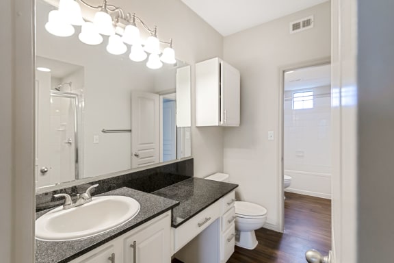 This is a picture of the second floor bathroom with walk-in shower in the 1320 square foot 2 bedroom, 2 and 1/2 bath floor plan at The Brownstones Townhome Apartments in Dallas, TX..