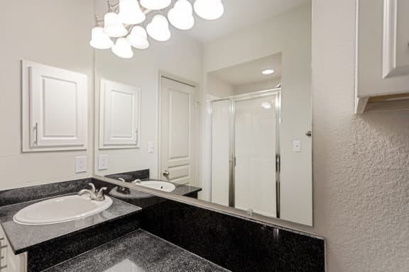 This is a picture of the second floor bathroom with walk-in shower in the 1320 square foot 2 bedroom, 2 and 1/2 bath floor plan at The Brownstones Townhome Apartments in Dallas, TX..