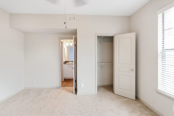 This is a picture of the second bedroom of the 1320 square foot 2 bedroom, 2 and 1/2 bath floor plan at The Brownstones Townhome Apartments in Dallas, TX..