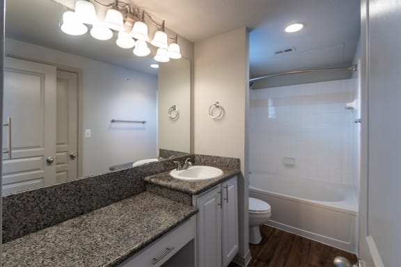 This is a photo of the primary bathroom of the 1486 square foot 3 bedroom, 3 bath floor plan at The Brownstones Townhome Apartments in Dallas, TX.