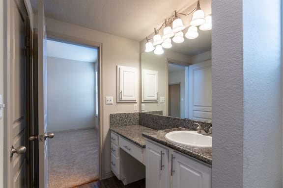 This is a photo of the primary bathroom of the 1486 square foot 3 bedroom, 3 bath floor plan at The Brownstones Townhome Apartments in Dallas, TX.