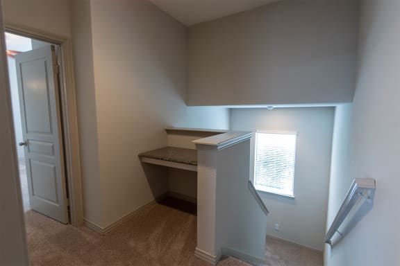 This is a photo of the built-in desk in the upstairs hallway of the 1486 square foot 3 bedroom, 3 bath floor plan at The Brownstones Townhome Apartments in Dallas, TX.