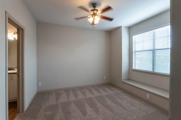 This is a photo of the second bedroom of the 1486 square foot 3 bedroom, 3 bath floor plan at The Brownstones Townhome Apartments in Dallas, TX.