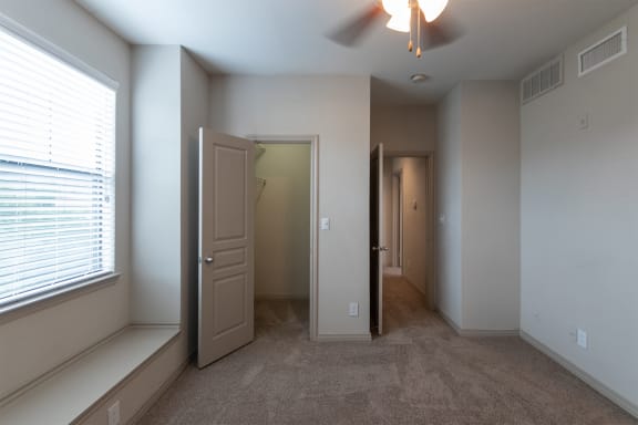 This is a photo of the second bedroom of the 1486 square foot 3 bedroom, 3 bath floor plan at The Brownstones Townhome Apartments in Dallas, TX.