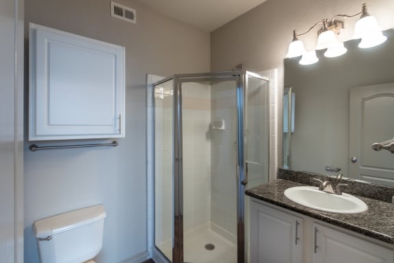 This is a photo of the bathroom in the second bedroom of the 1486 square foot 3 bedroom, 3 bath floor plan at The Brownstones Townhome Apartments in Dallas, TX.