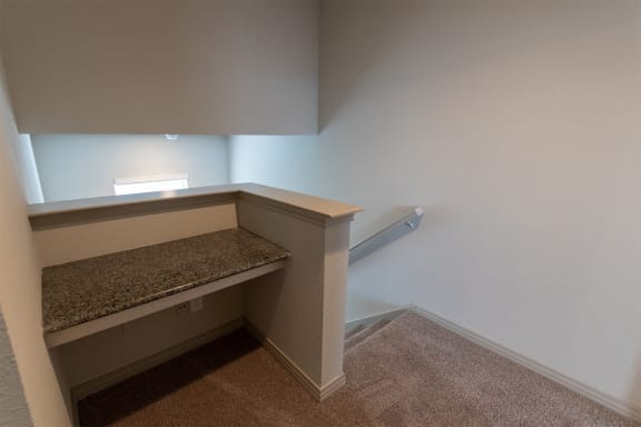 This is a photo of the built-in desk in the upstairs hallway of the 1486 square foot 3 bedroom, 3 bath floor plan at The Brownstones Townhome Apartments in Dallas, TX.