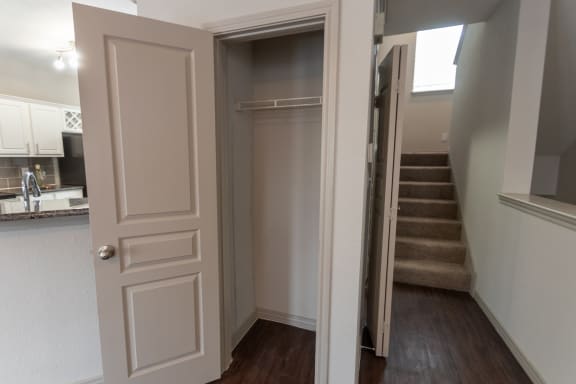 This is a photo of the closet in the living room of the 1486 square foot 3 bedroom, 3 bath floor plan at The Brownstones Townhome Apartments in Dallas, TX.