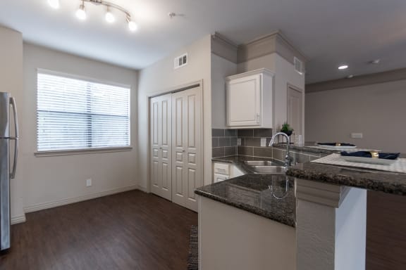This is a photo of the kitchen of the 1486 square foot 3 bedroom, 3 bath floor plan at The Brownstones Townhome Apartments in Dallas, TX.