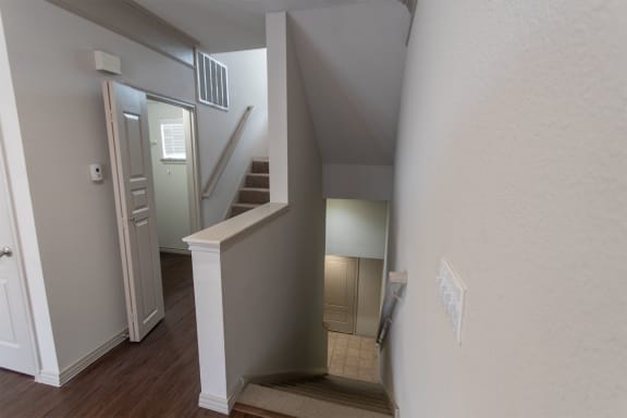 This is a photo of the entryway and stairwell to the third floor of the 1486 square foot 3 bedroom, 3 bath floor plan at The Brownstones Townhome Apartments in Dallas, TX.