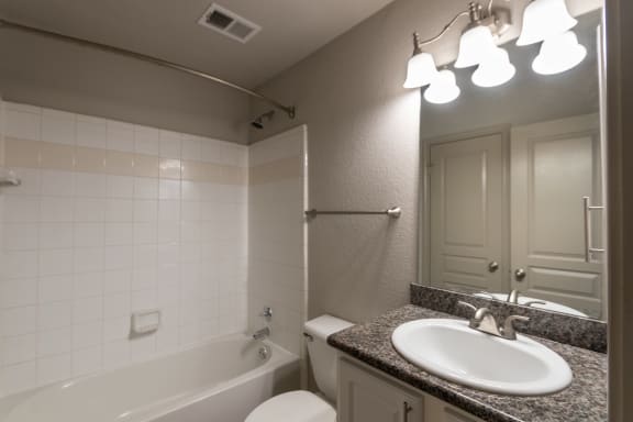 This is a photo of the downstairs bathroom of the 1486 square foot 3 bedroom, 3 bath floor plan at The Brownstones Townhome Apartments in Dallas, TX.