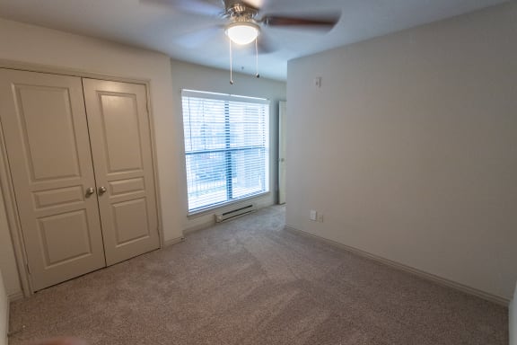 This is a photo of the third bedroom of the 1486 square foot 3 bedroom, 3 bath floor plan at The Brownstones Townhome Apartments in Dallas, TX.