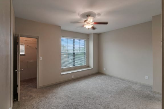 This is a photo of the primary bedroom of the 1661 square foot 3 bedroom, 3 and a half bath floor plan at The Brownstones Townhome Apartments in Dallas, TX.