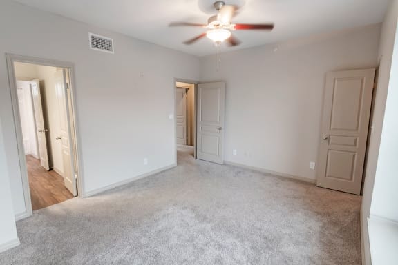 This is a photo of the primary bedroom of the 1661 square foot 3 bedroom, 3 and a half bath floor plan at The Brownstones Townhome Apartments in Dallas, TX.