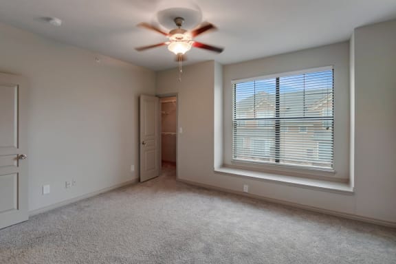 This is a photo of the primary bedroom of the 1661 square foot 3 bedroom, 3 and a half bath floor plan at The Brownstones Townhome Apartments in Dallas, TX.