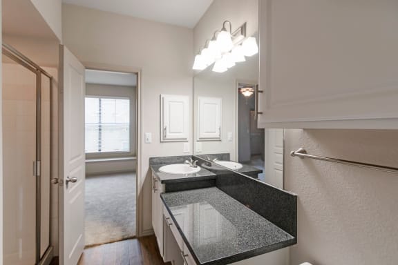 This is a photo of the third floor bathroom with walk-in shower in the 1661 square foot 3 bedroom, 3 and a half bath floor plan at The Brownstones Townhome Apartments in Dallas, TX.