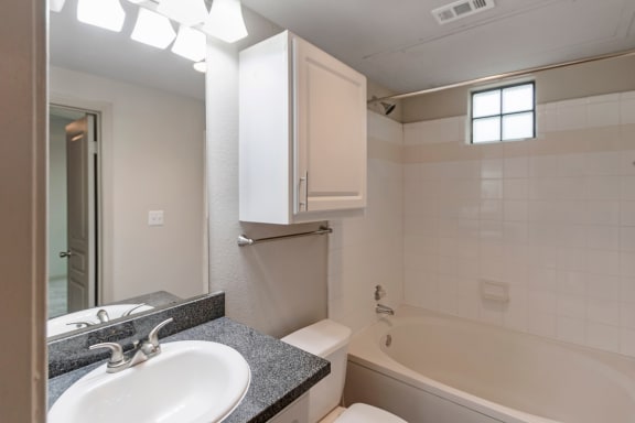 This is a photo of the third floor bathroom with full tub in the 1661 square foot 3 bedroom, 3 and a half bath floor plan at The Brownstones Townhome Apartments in Dallas, TX.