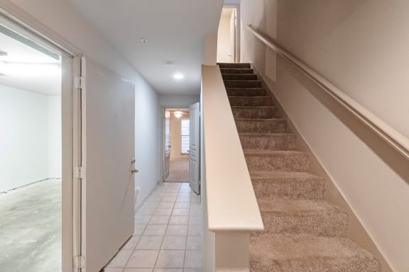 This is a photo of the first floor hallway of the 1661 square foot 3 bedroom, 3 and a half bath floor plan at The Brownstones Townhome Apartments in Dallas, TX.