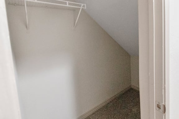 This is a photo of the first floor hallway closet in the 1661 square foot 3 bedroom, 3 and a half bath floor plan at The Brownstones Townhome Apartments in Dallas, TX.