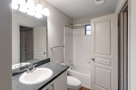 This is a photo of the first floor bathroom in the 1661 square foot 3 bedroom, 3 and a half bath floor plan at The Brownstones Townhome Apartments in Dallas, TX.