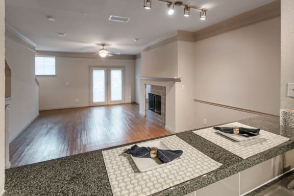 This is a photo of the living room and dining area of the 1661 square foot 3 bedroom, 3 and a half bath floor plan at The Brownstones Townhome Apartments in Dallas, TX.