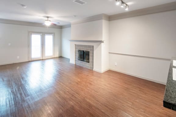 This is a photo of the living room and dining area of the 1661 square foot 3 bedroom, 3 and a half bath floor plan at The Brownstones Townhome Apartments in Dallas, TX.