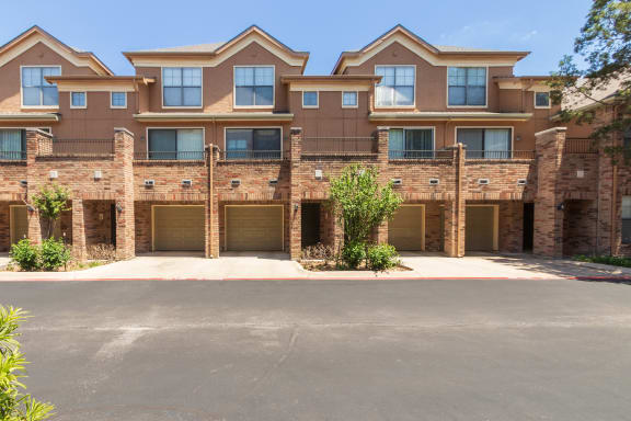 This is a photo of the building exteriors at The Brownstones Townhome Apartments in Dallas, TX.