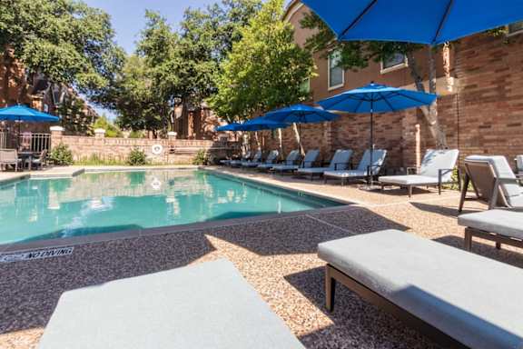 This is a photo of the pool area at The Brownstones Townhome Apartments in Dallas, TX.