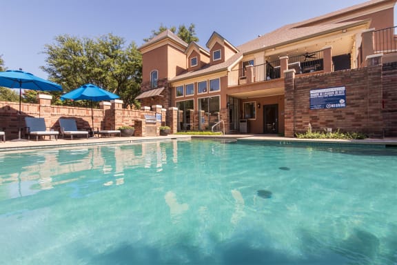 This is a photo of the pool area at The Brownstones Townhome Apartments in Dallas, TX.