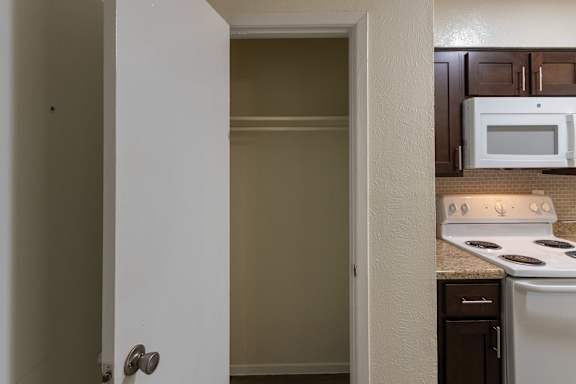 Entryway closet in a 1 bedroom, 1 bath C, 653 sq ft apartment home with hardwoodlike flooring throughout at The Biltmore Apartments located in the Vickery Midtown neighborhood of Dallas, TX.