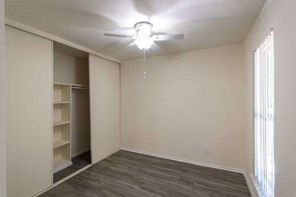 The den containing a closet with built-in shelving in a 1 bedroom, 1 bath 752 sq ft apartment home with hardwoodlike flooring throughout at The Biltmore Apartments located in the Vickery Midtown neighborhood of Dal