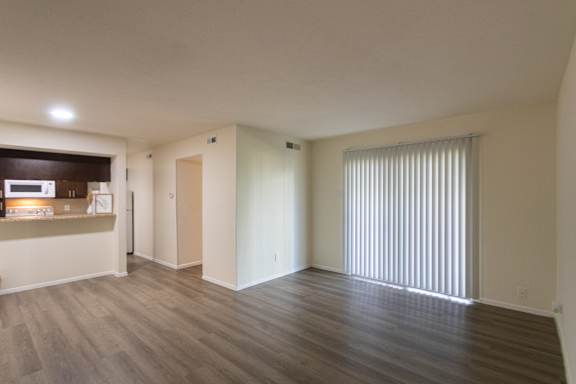 A view of the dining area and kitchen from the living room of a 1 bedroom, 1 bath B, 629 sq ft apartment home at The Biltmore Apartments located in the Vickery Midtown neighborhood of Dallas, TX.