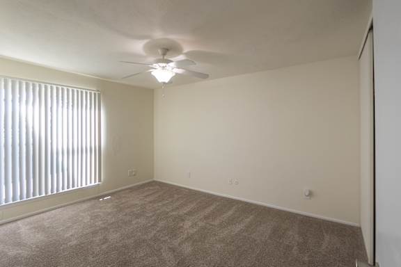 The primary bedroom in a 2 bedroom, 1.5 bath 1084 sq ft, 2-floor townhome at The Biltmore Apartments located in the Vickery Midtown neighborhood of Dallas, TX.