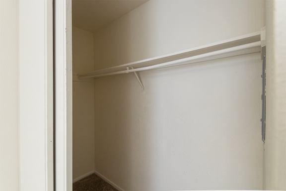 Primary bedroom closet in a 2 bedroom, 1.5 bath 1084 sq ft, 2-floor townhome at The Biltmore Apartments located in the Vickery Midtown neighborhood of Dallas, TX.