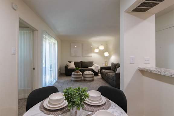 A dining table with plates and a plant on it in a 1 bedroom, 1 bath 554 sq ft apartment home at The Biltmore Apartments located in the Vickery Midtown neighborhood of Dallas, TX..