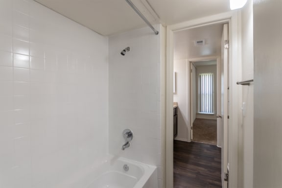 a bathroom with a bathtub and shower  at The Biltmore, Dallas, TX, 75231