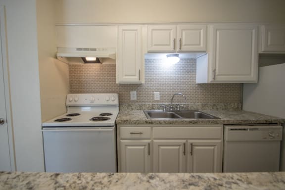 Kitchen With White Cabinetry And Appliances at The Biltmore, Dallas, Texas