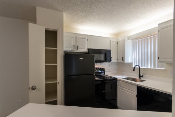 This is a photo of the kitchen in the 450 square foot efficiency apartment at Cambridge Court Apartments in Dallas, TX.