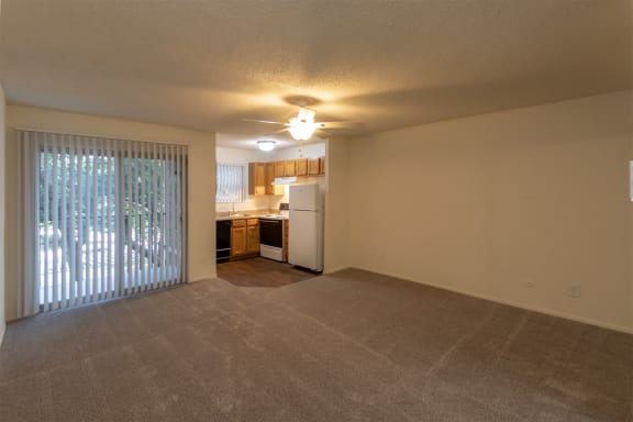 This is a photo of the kitchen from the other side of the living room in the 450 square foot efficiency apartment at Cambridge Court Apartments in Dallas, TX.