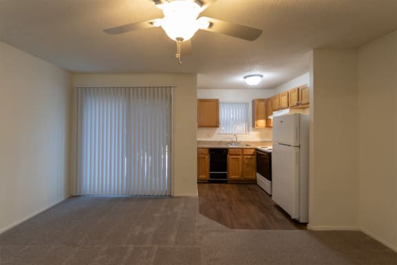 This is a photo of the patio doors and kitchen in the 450 square foot efficiency apartment at Cambridge Court Apartments in Dallas, TX.