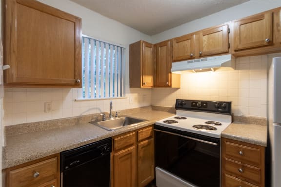 This is a photo of the kitchen in the 450 square foot efficiency apartment at Cambridge Court Apartments in Dallas, TX.
