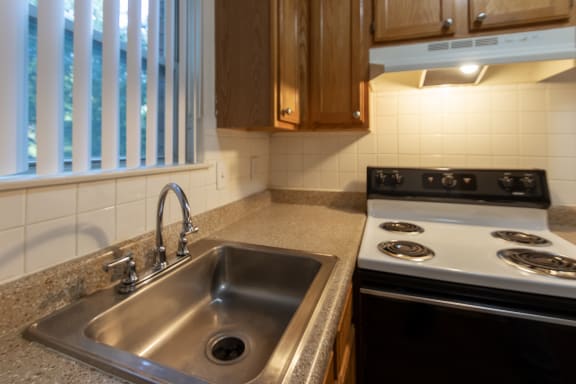 This is a photo of the kitchen in the 450 square foot efficiency apartment at Cambridge Court Apartments in Dallas, TX.