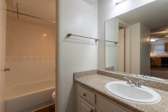 This is a photo of the bathroom in the 450 square foot efficiency apartment at Cambridge Court Apartments in Dallas, TX.