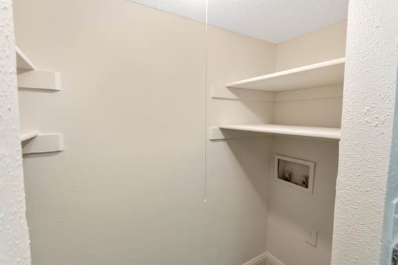This is a photo of the washer and dryer connections in the utility room of the 982 square foot 1 bedroom, 1 bath apartment at Cambridge Court Apartments in Dallas, TX.
