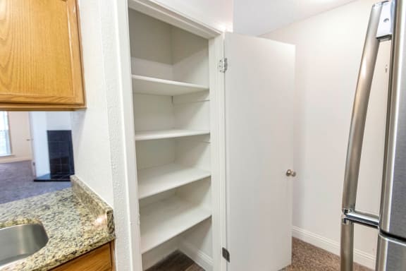 This is a photo of the pantry in the kitchen of  the 982 square foot 1 bedroom, 1 bath apartment at Cambridge Court Apartments in Dallas, TX.