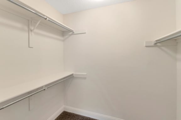 This is a photo of the walk-in closet in the bedroom of the 982 square foot 1 bedroom, 1 bath apartment at Cambridge Court Apartments in Dallas, TX.