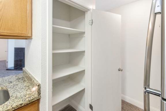 Kitchen pantry in the 982 square foot 1 bedroom, 1 bath apartment at Cambridge Court Apartments in Dallas, TX.