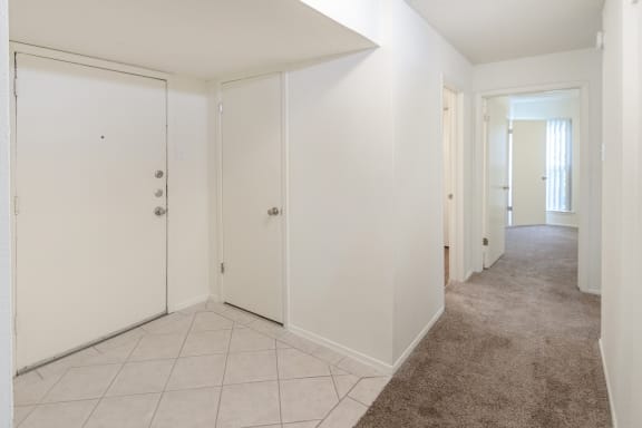 This is a photo of the hallway leading to the second bedroom in the 1245 square foot 2 bedroom, 2 bath apartment at Cambridge Court Apartments in Dallas, TX.