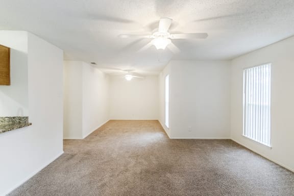 This is a photo of the living and dining rooms in the 1245 square foot 2 bedroom, 2 bath apartment at Cambridge Court Apartments in Dallas, TX.
